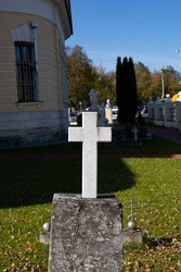 Marble white cross in the ancient church cemetery vertical photography