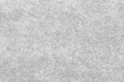 Soft grey felt material. Surface of felted fabric texture abstract background in gray color. High resolution photo.