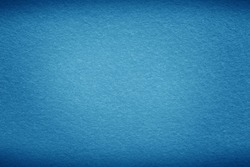Blue sea background texture with dark vignette. Blue felt fabric background with copy space for design. 
