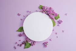 blossom Syringa vulgaris in Lilac flower and blank paper card for text message.Top view. Romantic flowers composition. Mock up frame with lilac flowers on purple background