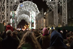 A crowd gathered in George Street, Edinburgh's City Center, Scotland, UK, watches the light show taking place during the events held in the city during the festive period.