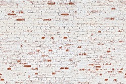 Seamless aged white brick wall with few shabby red bricks. Old grungy background with uneven stucco