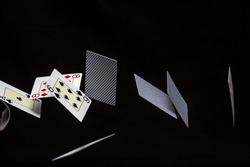 Flying playing cards. Black background