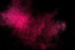 Abstract red and pink powder explosion on black background.