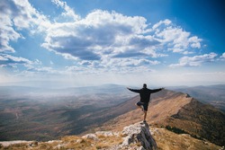 Young man boy doing yoga. Beautiful landscape  of mountains and sky in Serbia Rtanj. Hiking on top. Wallpaper