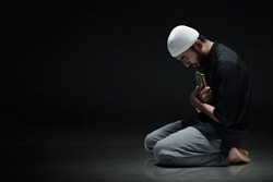 Religious asian muslim man holding holy quran