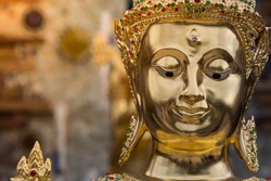 Face of Buddha statue golden close up in Thailand