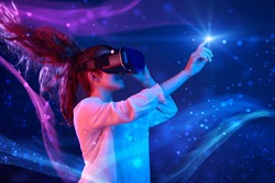 Woman with glasses of virtual reality. Future technology concept. Colorful neon lights.