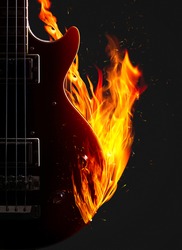 Electronic bass guitar enveloped flames on a black background.