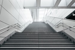 Stairs from underground upward in modern city space.