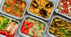 Food delivery.Different aluminium lunch box with healthy natural food pasta pesto, spelt, paella, quinoa, chicken salad, curry.  airlines food. airline meals and snacks . takeaway 