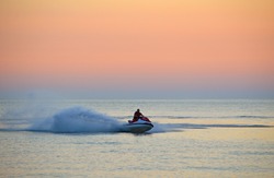 Resort vacation. Jet ski in the sea at sunset
