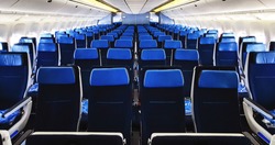 commercial airplane cabin interior with blue seats.