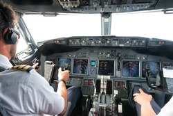 Flight Deck of small commercial aircraft.The pilots (cockpit crew) prepares for landing at the airport.