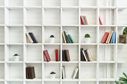 White wooden shelves with old books. Wooden bookcase.