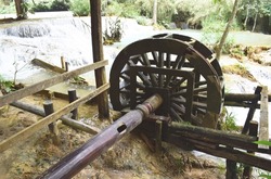 Working watermill wheel with falling water in the village.Laos PDR