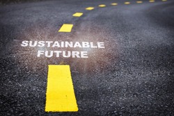 Sustainable future word on asphalt road surface with marking lines. Inspiration and motivation concept and effort idea