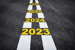 Happy new year concept and business opportunity idea. Future ahead 2023 to 2026 on asphalt road surface with marking lines