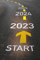 Start to new year from 2023 to 2027 with arrow marking on road. Five years startup business concept and beginning to success idea