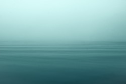 Fog and mist on open sea creating a mystical and quiet scene.