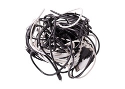 Black and white wires tangled together. Tangle of tangled wires usb and micro usb, audio cable jack. A coil of various wires for gadgets on a white background.
