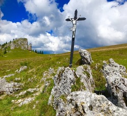 cruzifix in a rocky area high up in a mountain region/beautiful day for hiking, religious sign in Slowakia, Velka Fatra/trekking in the mountains, meadow, stones and religion
