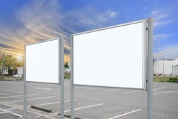 mock up of blank showcase billboard or advertising light box for your text message or media content with car in the parking lot in row, commercial, marketing and advertising concept.