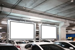 mock up of blank showcase billboard or advertising light box for your text message or media content with car in the parking lot in row, commercial, marketing and advertising concept. 