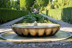 View of beautiful fountain from Alhambra gardens in Granada