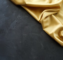 Gold silk fabric texture and black paint textured background template . Top view. copy space