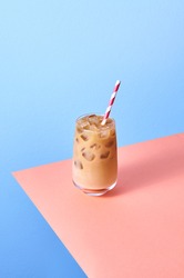 Iced Coffee with Milk in Tall Glasses on Pink Table and Blue Background. Isometric Vertical Orientation