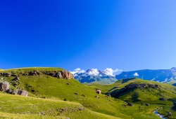 South Africa Drakensberg national park,Giants Castle,green scenic panorama,sunny blue sky,few clouds, mountains,valley creek 