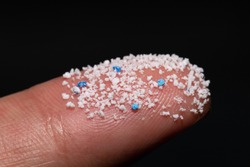 Small Plastic pellets on the finger.Micro plastic.air pollution