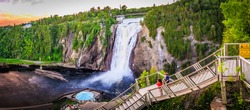 the heart of Quebec with this breathtaking photo of the Montmorency Falls. This stunning image captures the beauty and power of the large waterfall, set against the backdrop of the lush forest.