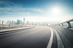 Highway overpass motion blur effect with modern city background