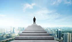 Success person climbed on top of the stairs looking at the cityscape. Success business concept. 
