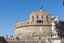  Castel Sant'Angelo (Holy Angel Castle) also known as The Mausoleum of Hadrian  and statues of angel figure on the Sant'Angelo bridge with flying bird in the background in Rome, Italy.