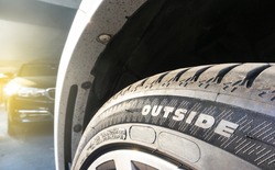 Selective focus of text outside wear on tire , Text indicating directions for wearing the tires on the wheels.