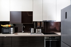 Kitchen cabinets and utensils, modern furnished contemporary kitchenette 