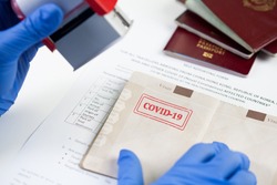 COVID-19 stamped passport ID,airport border customs health and safety security check,restrictive no entry measures due to SARS-CoV-2 corona virus disease epidemic,Coronavirus global pandemic,US  UK 