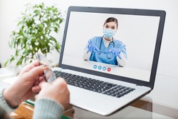 Virtual doctor visit,telemedicine healthcare concept,young female doctor giving advice over laptop computer screen to elderly woman,hands holding glasses medical worker on display,remote appointment