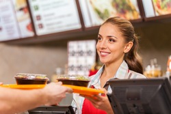 Restaurant worker serving two fast food meals with smile. woman holding tray with salads at fast food restaurant