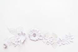 frame with white paper flowers on white background