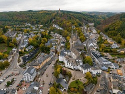 Aerial drone Shot of town CLervaux on the north of Luxembourg. Twilight evening scene with Castle and Cathedral