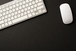 Above overhead view photo of wireless keyboard and mouse in white color isolated black backdrop with blank space