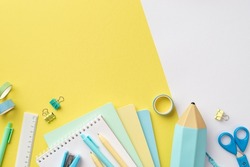 Back to school concept. Top view photo of colorful school supplies notepads pencil-case pens stapler binder clips scissors ruler adhesive tape on bicolor yellow and white background with empty space