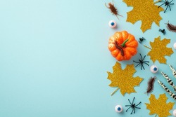 Halloween concept. Top view photo of pumpkin gold glitter maple leaves skeleton hand eyeballs spiders cockroach and centipedes on isolated pastel blue background with empty space