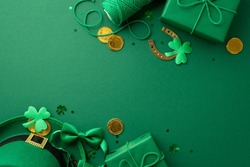 Saint Patrick's Day concept. Top view photo of leprechaun hat present boxes spool of twine gold coins bow-tie horseshoe clovers and confetti on isolated green background with copyspace