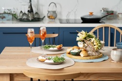Family breakfast or brunch set served on wooden table. Scandinavian blue  kitchen and cozy home concept