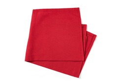 Red textile napkin isolated on white background. Folded decorative kitchen cotton towel. Top view